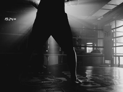 Silhouette of an athlete resting after a hard workout.